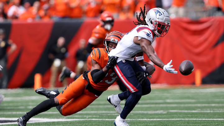 Sep 8, 2024; Cincinnati, Ohio, USA;  New England Patriots wide receiver K.J. Osborn (2) attempts the one hand catch as Cincinnati Bengals cornerback Dax Hill (23) defends during the first quarter at Paycor Stadium.