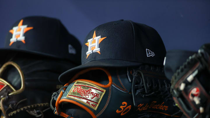 Apr 21, 2023; Atlanta, Georgia, USA; A detailed view of a Houston Astros hat and glove in the dugout against the Atlanta Braves in the fifth inning at Truist Park. Mandatory Credit: Brett Davis-Imagn Images