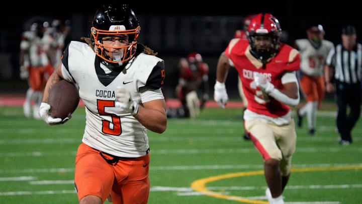 Cocoa High wide receiver Jayvan Boggs (5) finds room to run against the Cardinal Mooney defense on Friday night in a Class 2A state semifinal game. Boggs caught 17 passes for a state record 378 yards and three touchdowns in a 31-21 victory. Cocoa High wide receiver Jayvan Boggs (5) finds room to run against the Cardinal Mooney defense on Friday night in a Class 2A state semifinal game. Boggs caught 17 passes for a state record 378 yards and three touchdowns in a 31-21 victory.