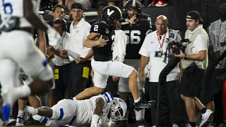 Sep 20, 2025; Nashville, Tennessee, USA;  Vanderbilt Commodores quarterback Diego Pavia (2) hurdles Georgia State Panthers linebacker Damaine Wilson (1) during the first half at FirstBank Stadium. Mandatory Credit: Steve Roberts-Imagn Images