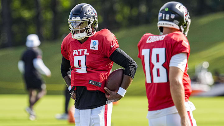 Jul 29, 2025; Atlanta, GA, USA; Atlanta Falcons quarterback Michael Penix Jr. (9) shown next to quarterback Kirk Cousins (18) during practice at training camp at IBM Performance Field.