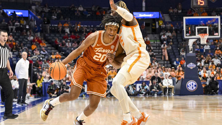 Mar 14, 2025; Nashville, TN, USA;  Texas Longhorns guard Tre Johnson (20) drives into Tennessee Volunteers guard Jahmai Mashack (15) during the second half at Bridgestone Arena. Mandatory Credit: Steve Roberts-Imagn Images
