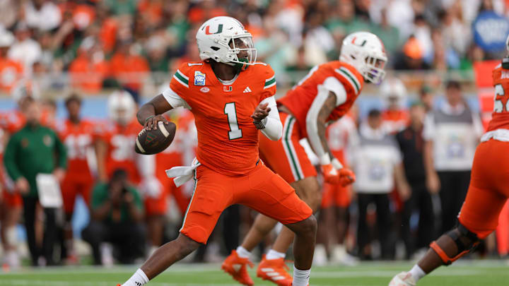 Dec 28, 2024; Orlando, FL, USA; Miami Hurricanes quarterback Cam Ward (1) drops back to pass against the Iowa State Cyclones in the first quarter during the Pop Tarts bowl at Camping World Stadium. Mandatory Credit: Nathan Ray Seebeck-Imagn Images