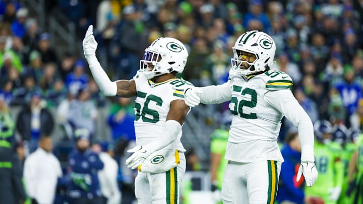 Green Bay Packers linebacker Edgerrin Cooper (56) celebrates with defensive end Rashan Gary (52) following a sack at Seattle.