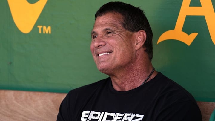 Aug 17, 2024; Oakland, California, USA; Oakland Athletics former outfielder Jose Canseco sits in the dugout before the game against the San Francisco Giants at Oakland-Alameda County Coliseum. Mandatory Credit: Darren Yamashita-Imagn Images