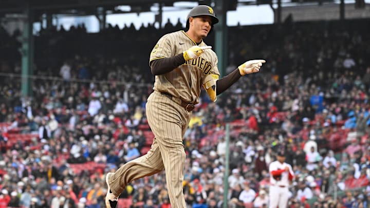Manny Machado (13) celebrates his three run home run against the Boston Red Sox during the fifth inning at Fenway Park. 
