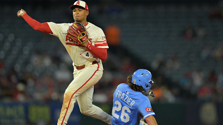 Sep 24, 2025; Anaheim, California, USA;  Kansas City Royals second baseman Adam Frazier (26) is out as Los Angeles Angels second baseman Christian Moore (4) throws to first for a double play in the eighth inning at Angel Stadium. Mandatory Credit: Jayne Kamin-Oncea-Imagn Images