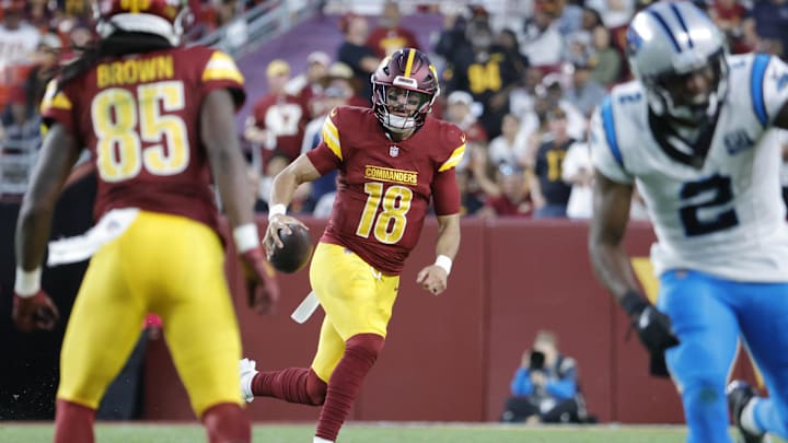 Oct 20, 2024; Landover, Maryland, USA; Washington Commanders quarterback Marcus Mariota (18) runs with the ball against the Carolina Panthers during the second half at Northwest Stadium. Mandatory Credit: Amber Searls-Imagn Images
