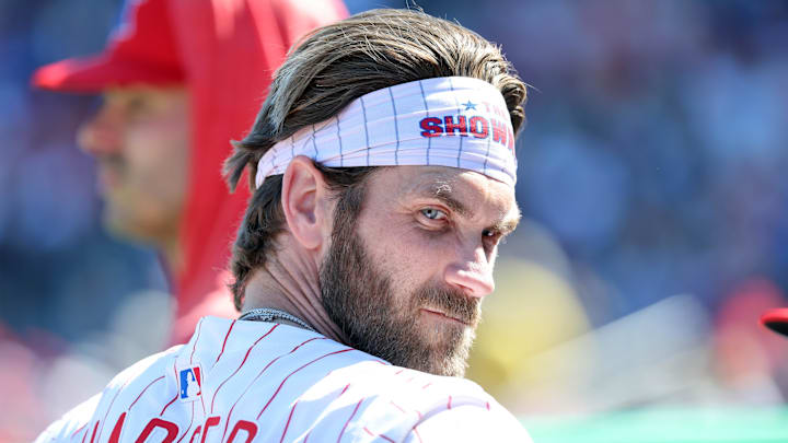 Feb 28, 2025; Clearwater, Florida, USA;  Philadelphia Phillies first base Bryce Harper (3) looks on in the dugout against the Boston Red Sox at BayCare Ballpark. 