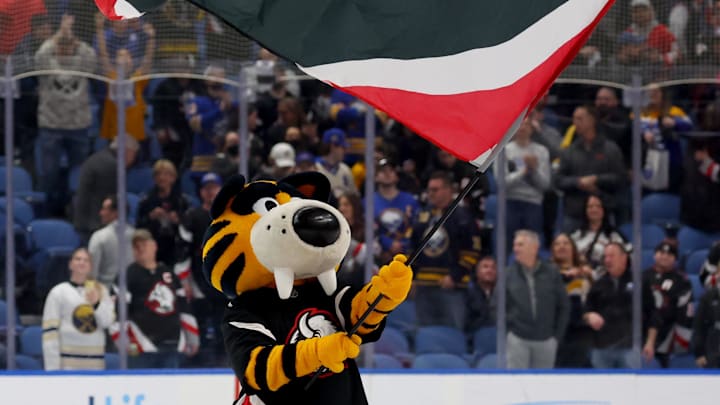 Apr 9, 2026; Buffalo, New York, USA; Buffalo Sabres mascot Sabretooth waves the flag after a win against the Columbus Blue Jackets at KeyBank Center. Mandatory Credit: Timothy T. Ludwig-Imagn Images Apr 9, 2026; Buffalo, New York, USA; Buffalo Sabres mascot Sabretooth waves the flag after a win against the Columbus Blue Jackets at KeyBank Center. Mandatory Credit: Timothy T. Ludwig-Imagn Images