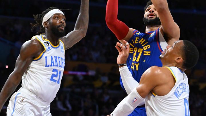 Oct 30, 2022; Los Angeles, California, USA;  Denver Nuggets guard Jamal Murray (27) is defended by Los Angeles Lakers guard Patrick Beverley (21) and guard Russell Westbrook (0) in the first half at Crypto.com Arena. Mandatory Credit: Jayne Kamin-Oncea-USA TODAY Sports