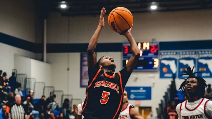 Sanford Seminole's Juan Tomlinson (5) goes up for a shot in an earlier game against Edgewater. He recently had 18 points on six 3-pointers and added two assists to guide the Seminoles past Winter Springs, 64-45.