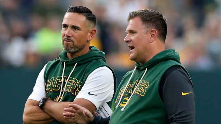 Green Bay Packers coach Matt LaFleur and general manager Brian Gutekunst talk on the field during Green Bay Packers Family Night.