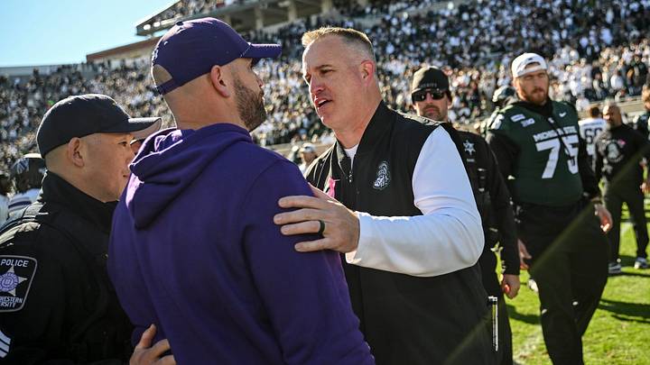 Michigan State coach Pat Fitzgerald, right, and Northwestern coach David Braun meet after Northwestern's 24-21 win on Saturday, Oct. 17, 2026, at Spartan Stadium in East Lansing.