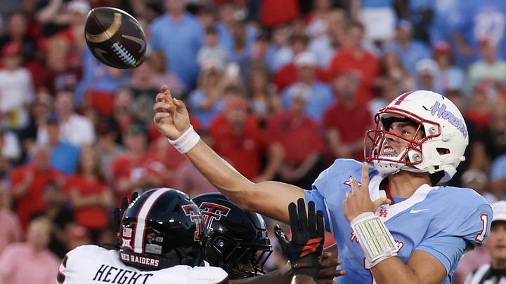 Oct 4, 2025; Houston, Texas, USA; Houston Cougars quarterback Conner Weigman (1) passes while being rushed by Texas Tech Red Raiders defensive end Romello Height (9) in the first half at TDECU Stadium. Mandatory Credit: Thomas Shea-Imagn Images