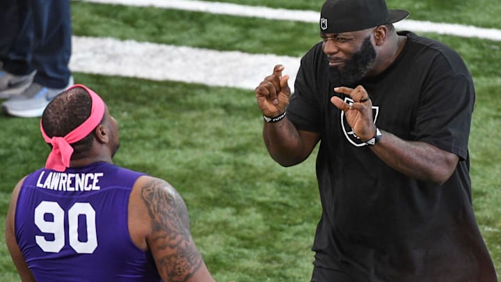 Defensive lineman Dexter Lawrence listens to NFL scout Brentson Buckner, a former Clemson defensive end and pro football player working for the Raiders, during Clemson Pro Day at the Poe Indoor Facility in Clemson, S.C. Thursday, March 14, 2019.

Clemson Pro Day 2019