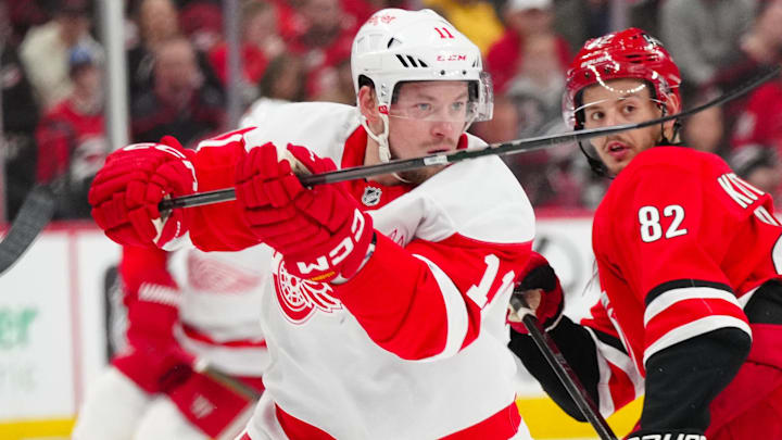 Mar 14, 2025; Raleigh, North Carolina, USA;  Detroit Red Wings right wing Vladimir Tarasenko (11) takes a shot against the Carolina Hurricanes during the second period at Lenovo Center. Mandatory Credit: James Guillory-Imagn Images