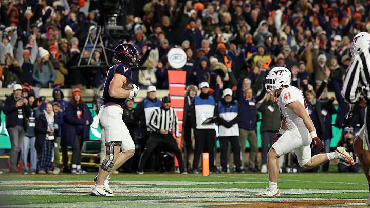 Nov 29, 2025; Charlottesville, Virginia, USA; Virginia Cavaliers tight end Sage Ennis (0) catches a touchdown pass behind Virginia Tech Hokies linebacker George Ballance (41) in the second quarter at Scott Stadium. Mandatory Credit: Geoff Burke-Imagn Images