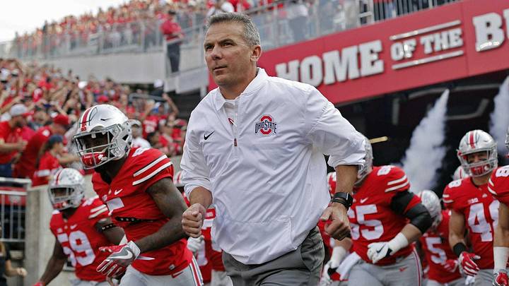 Urban Meyer, here leading Ohio State on the field in a 2016 game, coached the Buckeyes to an 83-9 record in seven seasons.