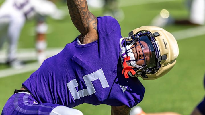 Christian Moss stretches out in the Huskies' 12th spring practice. Christian Moss stretches out in the Huskies' 12th spring practice.