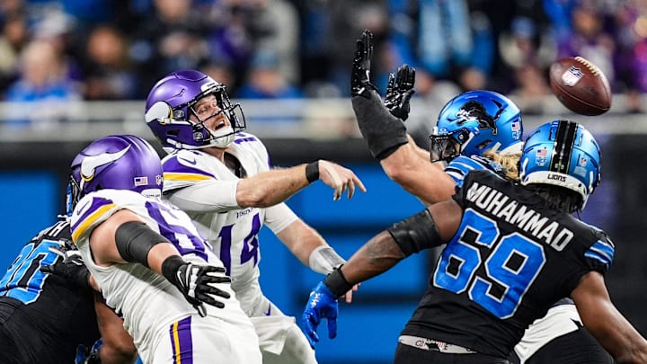 Minnesota Vikings quarterback Sam Darnold (14) is pressured by Detroit Lions linebacker Alex Anzalone (34) and linebacker Al-Quadin Muhammad (69) during the second half at Ford Field in Detroit on Sunday, Jan. 5, 2025.