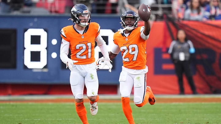 Oct 27, 2024; Denver, Colorado, USA; Denver Broncos cornerback Ja'Quan McMillian (29) celebrates his turnover with cornerback Riley Moss (21) in the second half against the Carolina Panthers at Empower Field at Mile High. 