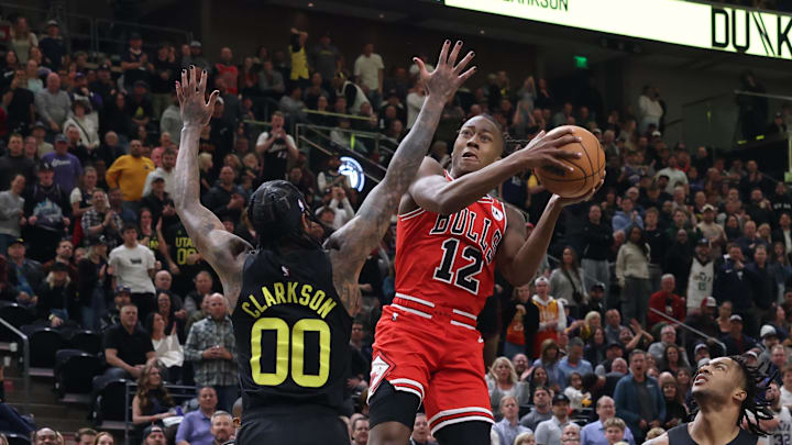 Mar 6, 2024; Salt Lake City, Utah, USA; Chicago Bulls guard Ayo Dosunmu (12) goes to the basket against Utah Jazz guard Jordan Clarkson (00) during the fourth quarter at Delta Center. Mandatory Credit: Rob Gray-Imagn Images
