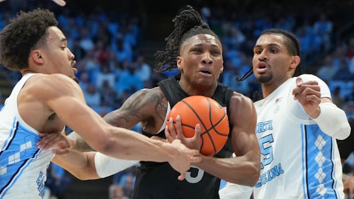 Feb 28, 2026; Chapel Hill, North Carolina, USA; Virginia Tech Hokies guard Ben Hammond (3) with the ball as North Carolina Tar Heels guard Seth Trimble (7) and forward Jarin Stevenson (15) defend in the first half at Dean E. Smith Center. Mandatory Credit: Bob Donnan-Imagn Images