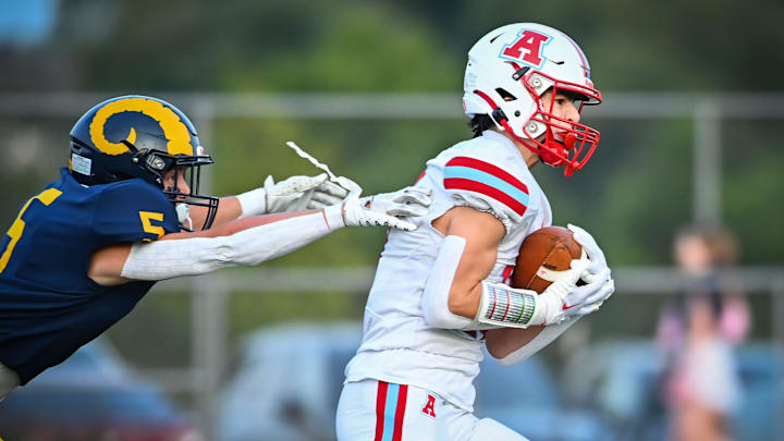 Arrowhead wide receiver Harper Hughes (15) eludes Marquette defensive back Nick Womack (5) for a long touchdown catch in a game Thursday, August 17, 2023.