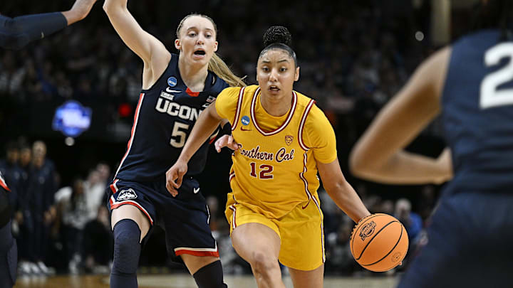 Apr 1, 2024; Portland, OR, USA; USC Trojans guard JuJu Watkins (12) drives to the basket during the second half against UConn Huskies guard Paige Bueckers (5) in the finals of the Portland Regional of the NCAA Tournament at the Moda Center. Mandatory Credit: Troy Wayrynen-Imagn Images Apr 1, 2024; Portland, OR, USA; USC Trojans guard JuJu Watkins (12) drives to the basket during the second half against UConn Huskies guard Paige Bueckers (5) in the finals of the Portland Regional of the NCAA Tournament at the Moda Center. Mandatory Credit: Troy Wayrynen-Imagn Images