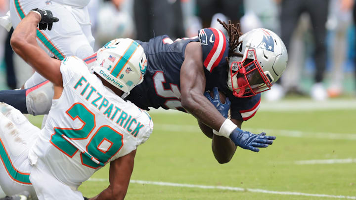 Sep 14, 2025; Miami Gardens, Florida, USA; New England Patriots running back Rhamondre Stevenson (38) carries the football against Miami Dolphins safety Minkah Fitzpatrick (29) during the fourth quarter at Hard Rock Stadium. Mandatory Credit: Sam Navarro-Imagn Images Sep 14, 2025; Miami Gardens, Florida, USA; New England Patriots running back Rhamondre Stevenson (38) carries the football against Miami Dolphins safety Minkah Fitzpatrick (29) during the fourth quarter at Hard Rock Stadium. Mandatory Credit: Sam Navarro-Imagn Images