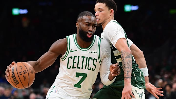 Feb 1, 2026; Boston, Massachusetts, USA; Boston Celtics guard Jaylen Brown (7) controls the ball while Milwaukee Bucks guard Ryan Rollins (13) defends during the second half at TD Garden. Mandatory Credit: Bob DeChiara-Imagn Images