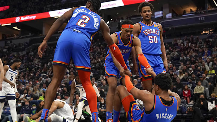 Jan 5, 2022; Minneapolis, Minnesota, USA; Oklahoma City Thunder guard Aaron Wiggins (21) is helped from the floor by guard Shai Gilgeous-Alexander (2) and forward Darius Bazley (7) against the Minnesota Timberwolves during the third quarter at Target Center. Mandatory Credit: Nick Wosika-Imagn Images Jan 5, 2022; Minneapolis, Minnesota, USA; Oklahoma City Thunder guard Aaron Wiggins (21) is helped from the floor by guard Shai Gilgeous-Alexander (2) and forward Darius Bazley (7) against the Minnesota Timberwolves during the third quarter at Target Center. Mandatory Credit: Nick Wosika-Imagn Images