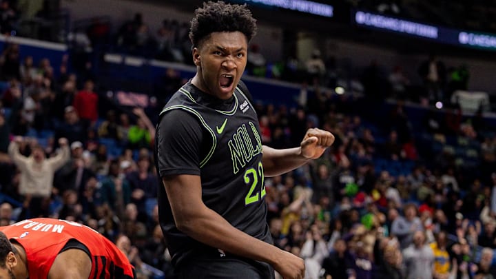 Dec 11, 2025; New Orleans, Louisiana, USA; New Orleans Pelicans center Derik Queen celebrates against Portland Trail Blazers forward Kris Murray during the second half at Smoothie King Center. 