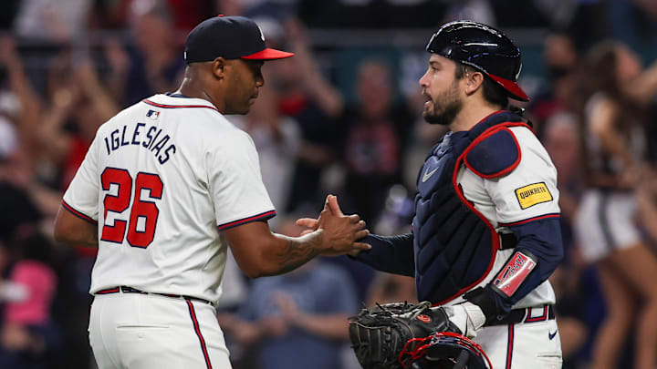 Sep 24, 2024; Atlanta, Georgia, USA; Atlanta Braves relief pitcher Raisel Iglesias (26) and catcher Travis d'Arnaud (16) celebrate after a victory over the New York Mets at Truist Park. Mandatory Credit: Brett Davis-Imagn Images
