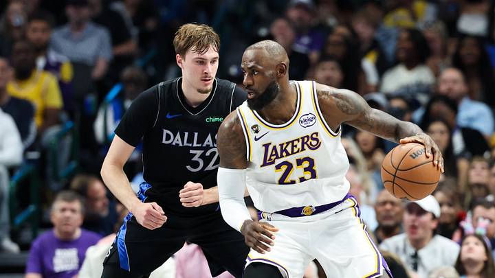 Apr 5, 2026; Dallas, Texas, USA;  Los Angeles Lakers forward LeBron James (23) controls the ball as  Dallas Mavericks forward Cooper Flagg (32) defends 