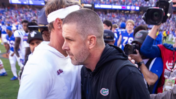 Florida Gators head coach Billy Napier and Mississippi Rebels head coach Lane Kiffin meet on the 50 yard line after the game at Ben Hill Griffin Stadium in Gainesville, FL on Saturday, November 23, 2024. The Gators defeated the Rebels 24-17 [Doug Engle/Gainesville Sun]
