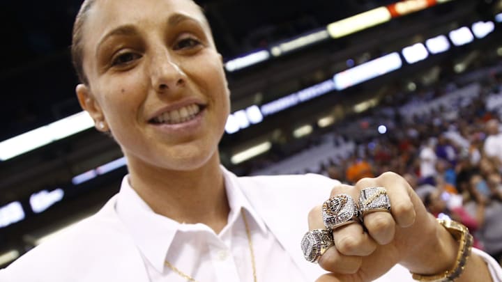 Phoenix Mercury star Diana Taurasi shows off her three WNBA Championship rings during ceremonies at the season opener on June 5, 2015, at US Airways Center in Phoenix.