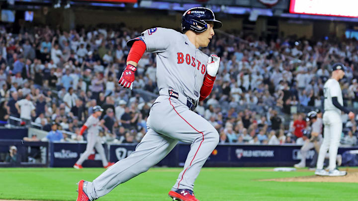 Sep 30, 2025; Bronx, New York, USA; Boston Red Sox outfielder Masataka Yoshida (7) hits a two run RBI during the seventh inning against the New York Yankees during game one of the Wildcard round for the 2025 MLB playoffs at Yankee Stadium. Mandatory Credit: Brad Penner-Imagn Images