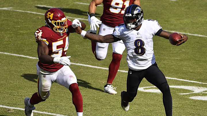 Oct 4, 2020; Landover, Maryland, USA; Baltimore Ravens quarterback Lamar Jackson (8) is forced out of bounds by Washington Football Team outside linebacker Kevin Pierre-Louis (54) during the second half at FedExField. Mandatory Credit: Brad Mills-Imagn Images