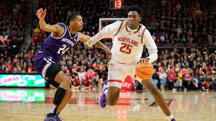 Mar 8, 2025; College Park, Maryland, USA; Maryland Terrapins center Derik Queen (25) handles the ball against Northwestern Wildcats guard K.J. Windham (24) during the second half at Xfinity Center. Mandatory Credit: Reggie Hildred-Imagn Images