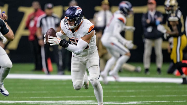 Oct 17, 2024; New Orleans, Louisiana, USA; Denver Broncos linebacker Cody Barton (55) runs back an interception for a touchdown against New Orleans Saints quarterback Spencer Rattler during the fourth quarter at Caesars Superdome. Mandatory Credit: Matthew Hinton-Imagn Images