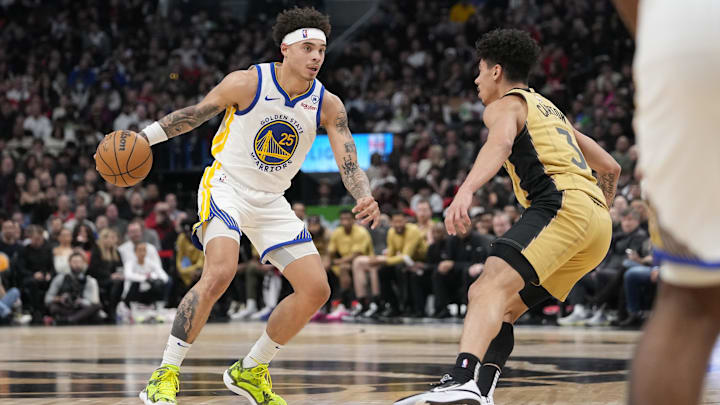 Mar 1, 2024; Toronto, Ontario, CAN; Golden State Warriors guard Lester Quinones (25) tries to get around Toronto Raptors guard DJ Carton (3) during the second half at Scotiabank Arena. Mandatory Credit: John E. Sokolowski-Imagn Images