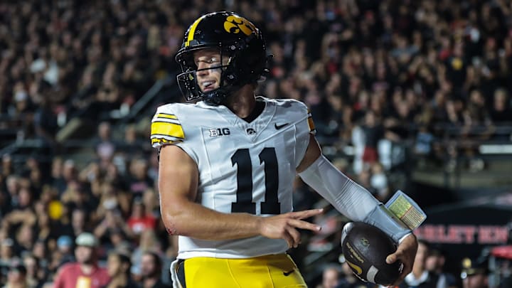 Sep 19, 2025; Piscataway, New Jersey, USA; Iowa Hawkeyes quarterback Mark Gronowski (11) celebrates after scoring a rushing touchdown during the first half against the Rutgers Scarlet Knights at SHI Stadium. Mandatory Credit: Vincent Carchietta-Imagn Images