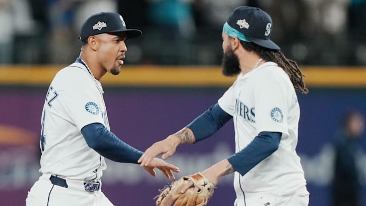 Julio Rodriguez (44) and shortstop J.P. Crawford (3) celebrate.