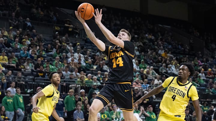 Iowa’s Bennett Stirtz, center, goes up for a shot against Oregon during the first half at Matthew Knight Arena in Eugene Feb 1, 2026.