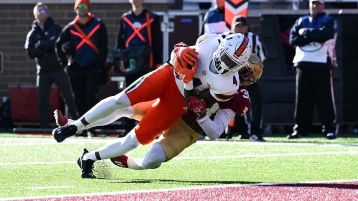 Nov 24, 2023; Chestnut Hill, Massachusetts, USA; Miami Hurricanes wide receiver Colbie Young (4) dives for a touchdown against the Boston College Eagles during the first half at Alumni Stadium. Mandatory Credit: Brian Fluharty-USA TODAY Sports