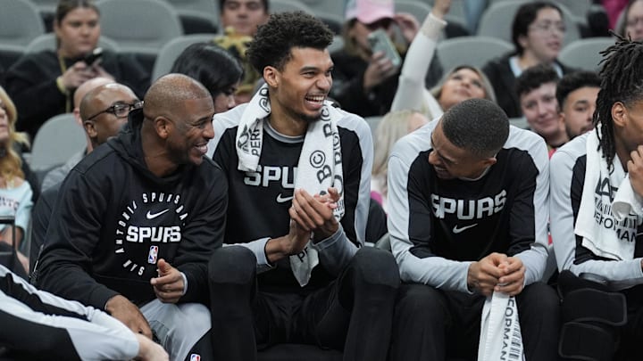 Dec 31, 2024; San Antonio, Texas, USA; San Antonio Spurs guard Chris Paul (3), center Victor Wembanyama (1), and forward Keldon Johnson (0) have a laugh in the second half against the LA Clippers at Frost Bank Center.