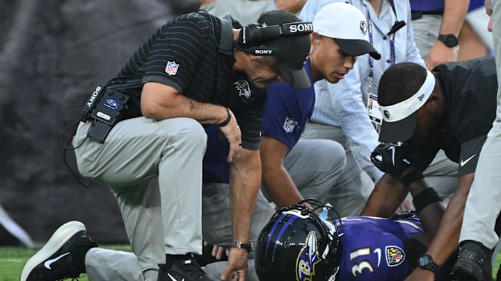 Aug 7, 2025; Baltimore, Maryland, USA; Baltimore Ravens head coach John Harbaugh (left) checks on Baltimore Ravens cornerback Bilhal Kone (31) who was injured on the play against the Indianapolis Colts during the first quarter at M&T Bank Stadium. Mandatory Credit: Rafael Suanes-Imagn Images