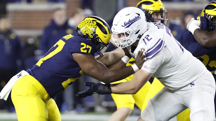 Nov 23, 2024; Ann Arbor, Michigan, USA;  Northwestern Wildcats offensive lineman Caleb Tiernan (72) blocks Michigan Wolverines defensive end Tyler McLaurin (27) in the second half at Michigan Stadium. Mandatory Credit: Rick Osentoski-Imagn Images